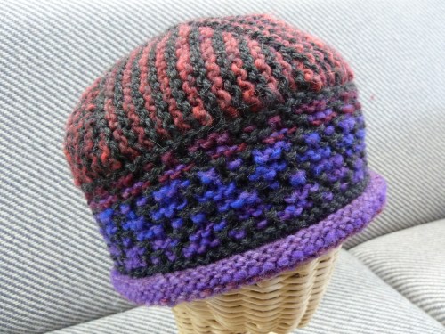 Noro Kureyon in reds/purples plus Charcoal Cascade 220