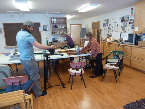 Susan cutting cloth strips for a rug